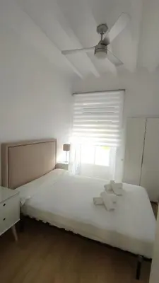 a bedroom with a bed with two towels on it at Tanguillo by Gades Gestión in Cádiz