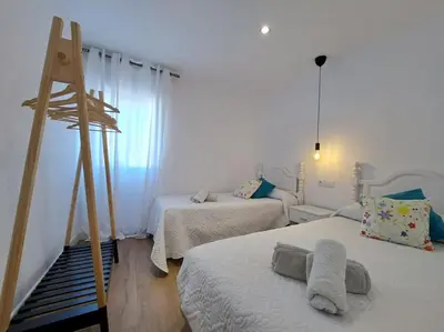 a bedroom with two beds and a ladder at Avda de las Piletas, segunda línea de playa in Sanlúcar de Barrameda
