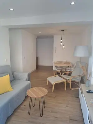 a living room with a couch and a table at Avda de las Piletas, segunda línea de playa in Sanlúcar de Barrameda
