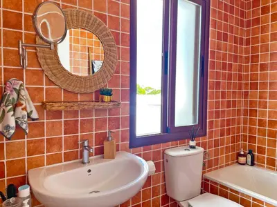 a bathroom with a sink and a toilet and a mirror at Apartamento Ronda de la Luz - Ole Solutions in Jerez de la Frontera