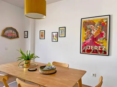 a dining room with a table and a movie poster at Apartamento Ronda de la Luz - Ole Solutions in Jerez de la Frontera