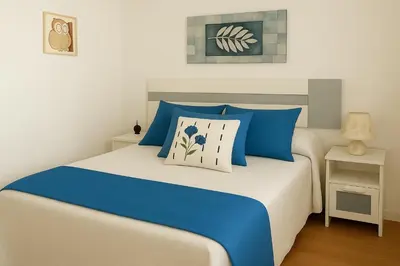 a bedroom with a bed with blue and white pillows at 