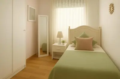 a bedroom with a bed with a green blanket at 