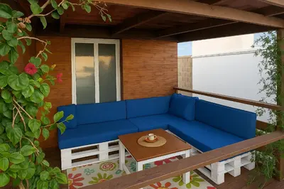 a blue couch and a table on a balcony at 