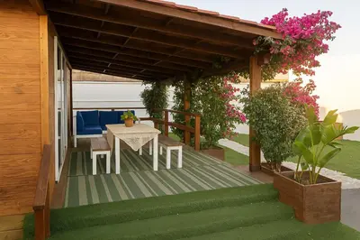 a wooden pergola with a table and chairs on a patio at 