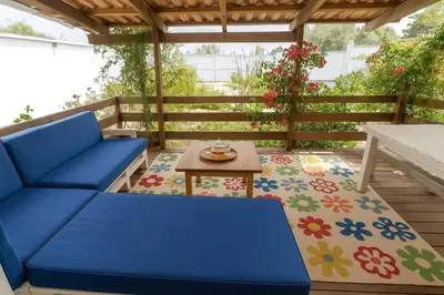 a blue couch and a table on a patio at 