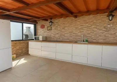 a kitchen with white cabinets and a brick wall at 