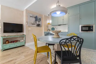 a kitchen with a table and chairs in a room at Cathedral Keepers - Exclusive apartment in Jerez in Jerez de la Frontera