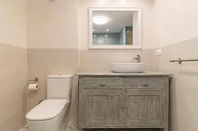 a bathroom with a sink and a toilet and a mirror at Cathedral Keepers - Exclusive apartment in Jerez in Jerez de la Frontera