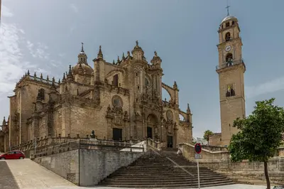 an old building with a clock tower and stairs at Cathedral Keepers - Exclusive apartment in Jerez in Jerez de la Frontera