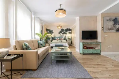 a living room with a couch and a tv at Cathedral Keepers - Exclusive apartment in Jerez in Jerez de la Frontera