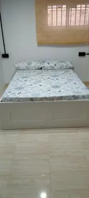a large bed in a room with a wooden floor at MiaEle in Sanlúcar de Barrameda