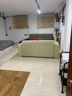 a living room with a couch and a table at MiaEle in Sanlúcar de Barrameda