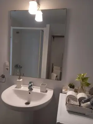 a bathroom with a white sink and a mirror at Alegrías de Cádiz by Gades Gestión in Cádiz