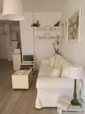 a living room with a white couch and a table at Alegrías de Cádiz by Gades Gestión in Cádiz