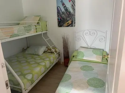 a small room with two bunk beds in it at Apartamento in Sanlúcar de Barrameda