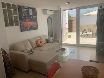a living room with a couch and a table at Apartamento in Sanlúcar de Barrameda