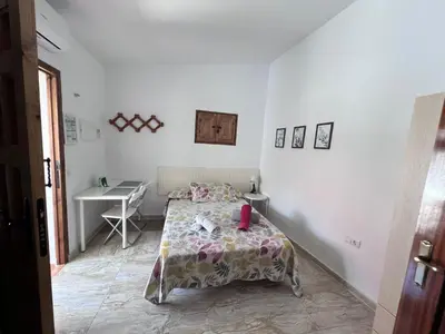 a small bedroom with a bed and a desk at Apartamentos La Campana 5 in Jerez de la Frontera