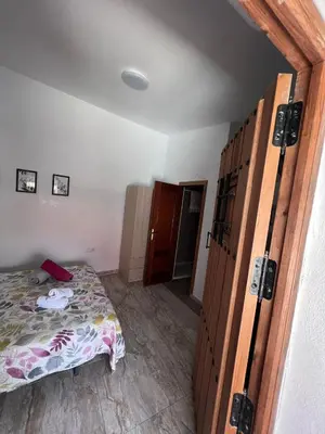 a bedroom with a bed and a large wooden door at Apartamentos La Campana 5 in Jerez de la Frontera