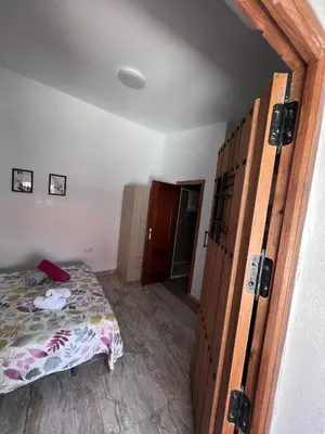 a bedroom with a bed and a door to a room at Apartamentos La Campana 5 in Jerez de la Frontera