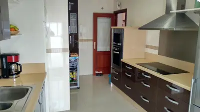 a kitchen with a sink and a stove at AMPLIO PISO EN COSTA BALLENA A 100 M DE LA PLAYA in Costa Ballena