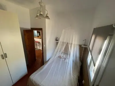 a bedroom with a bed with a mosquito net at La Marciana - piscina pista tenis futbol y baloncesto privado - Bungalow externo independiente in Chiclana de la Frontera