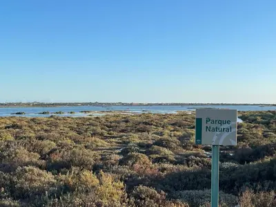 a sign in the middle of a field with water at La Marciana - piscina pista tenis futbol y baloncesto privado - Bungalow externo independiente in Chiclana de la Frontera