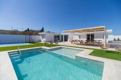a swimming pool in the backyard of a house at Complejoschiclana in Chiclana de la Frontera