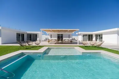 a swimming pool in front of a house at Complejoschiclana in Chiclana de la Frontera