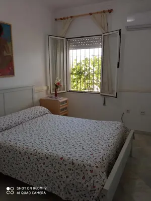 a bedroom with a bed and a window at Casa Mirador del Lago in Arcos de la Frontera