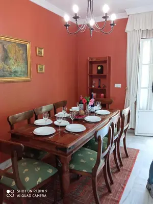 a dining room with a wooden table and chairs at Casa Mirador del Lago in Arcos de la Frontera