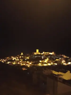 a view of a city lit up at night at Casa Mirador del Lago in Arcos de la Frontera