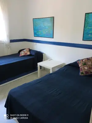a hotel room with two beds and a table at Casa Mirador del Lago in Arcos de la Frontera