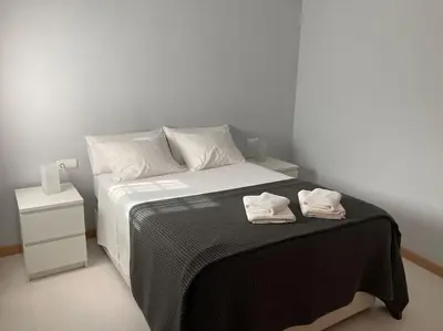 a bedroom with a bed with two towels on it at Apartamento en el centro a 200 m de la playa in Cádiz