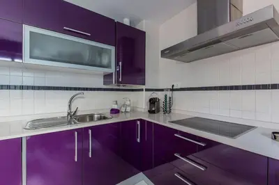 a kitchen with purple cabinets and a sink at Apartamento en el centro a 200 m de la playa in Cádiz
