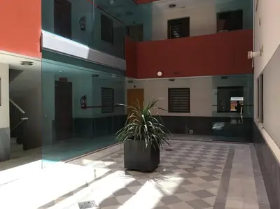 a potted plant sitting in the middle of a building at Apartamento en el centro a 200 m de la playa in Cádiz