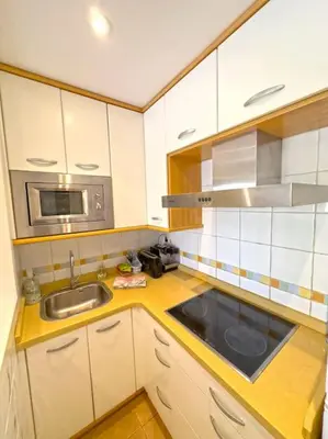 a kitchen with a sink and a microwave at Apartamento Puerta del Mar in Cádiz