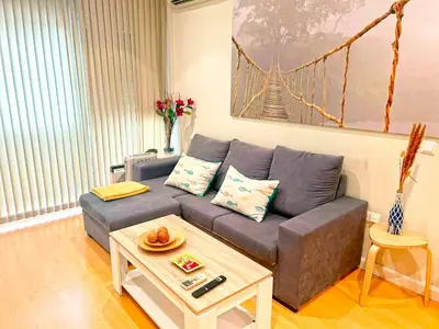 a living room with a couch and a coffee table at Apartamento Puerta del Mar in Cádiz