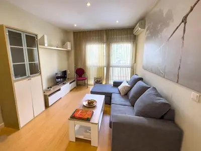a living room with a couch and a table at Apartamento Puerta del Mar in Cádiz