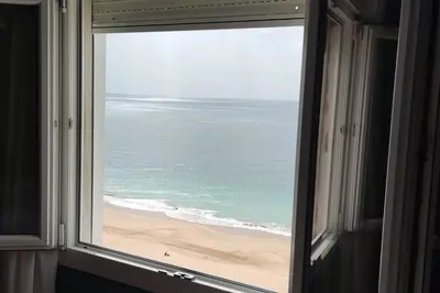 an open window with a view of the beach at 1ª Línea de playa, ESPECTACULARES VISTAS, GARAJE, WIFI in Rota