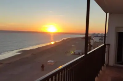 a sunset on the beach from a balcony at 1ª Línea de playa, ESPECTACULARES VISTAS, GARAJE, WIFI in Rota