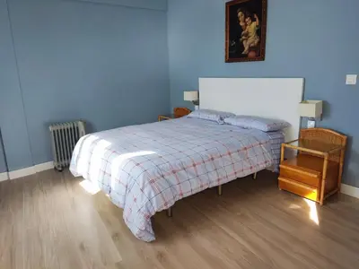 a blue bedroom with a bed with a plaid blanket at 1ª Línea de playa, ESPECTACULARES VISTAS, GARAJE, WIFI in Rota