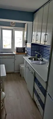 a small kitchen with a sink and a stove at 1ª Línea de playa, ESPECTACULARES VISTAS, GARAJE, WIFI in Rota