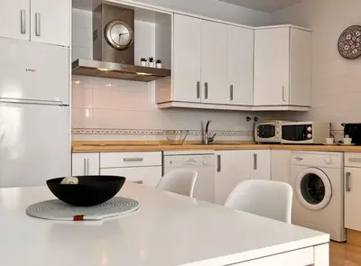 a kitchen with white cabinets and a black bowl on a counter at SibsSanlucar Carril SanDiego Centro Familias Garaje in Sanlúcar de Barrameda