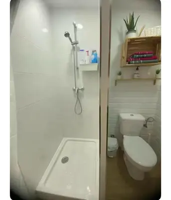 a white bathroom with a toilet and a sink at CASITA PINYPON in Jerez de la Frontera