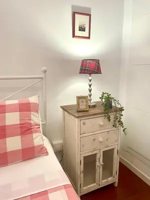 a bedroom with a bed and a lamp on a night stand at GATU PREMIUM La Brisa 