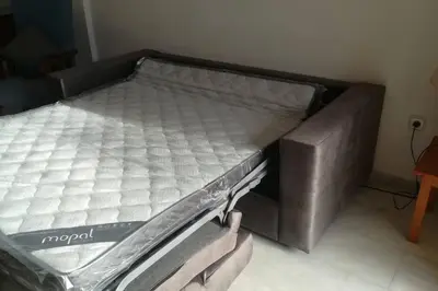 a bed with an empty mattress in a room at Dúplex en primera línea de playa 15 in Sanlúcar de Barrameda