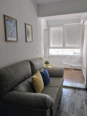 a living room with a couch and a table at Apartamento Puertomar in El Puerto de Santa María