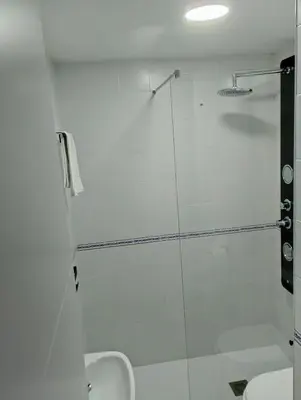 a bathroom with a glass shower with a sink at Apartamento Puertomar in El Puerto de Santa María