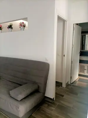 a living room with a couch and a hallway at Castelar in Rota